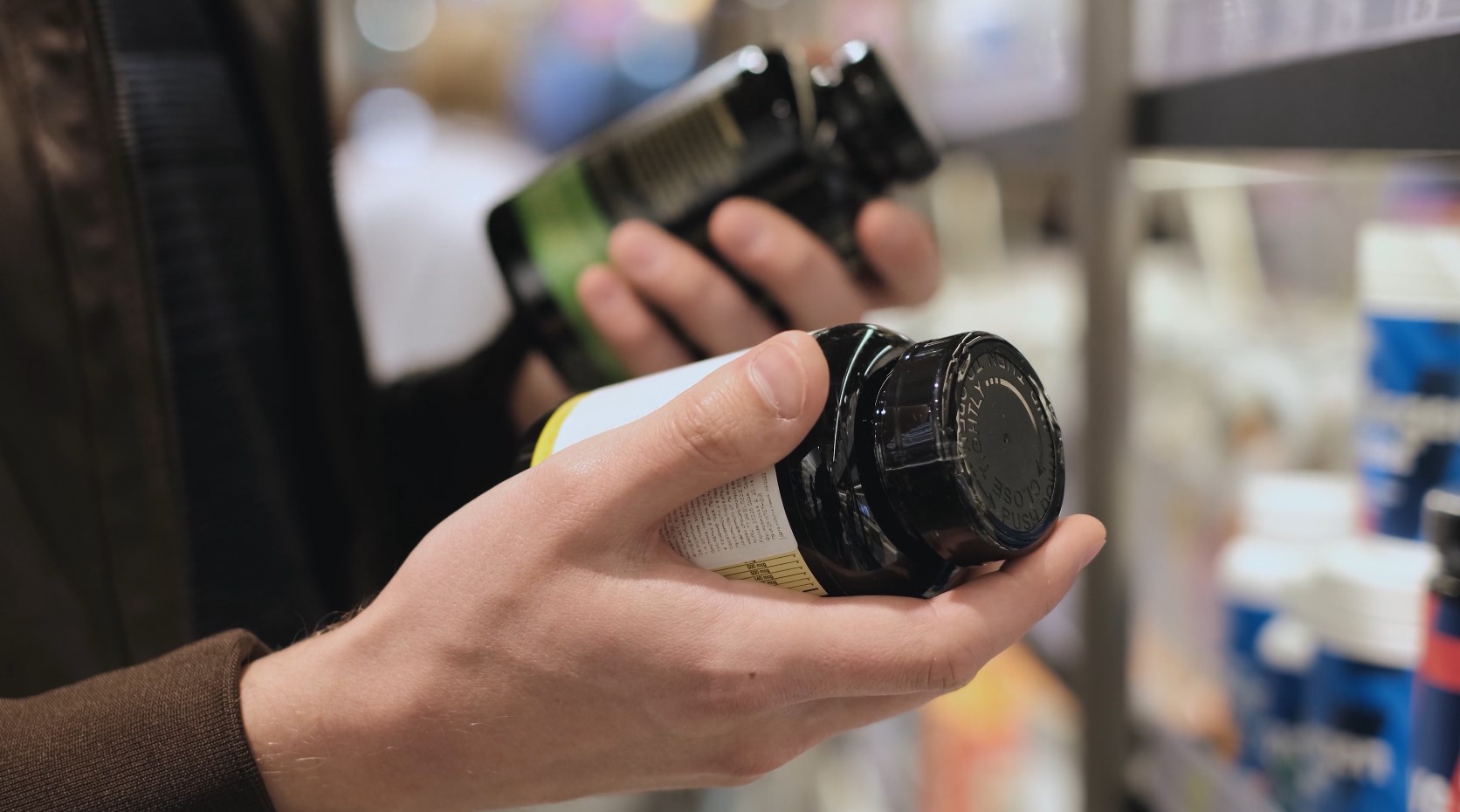 Pharmacy customer holding a prescription bottle