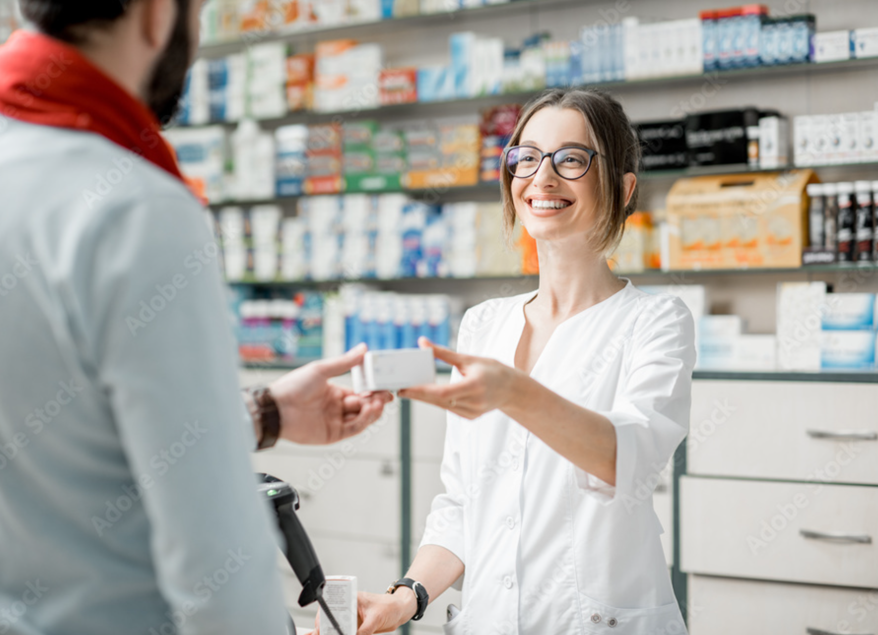 Pharmacist handing medication to a customer